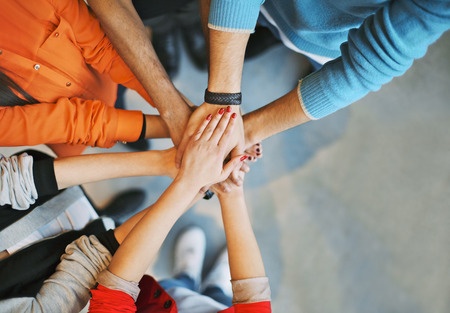 Group of people with hands together