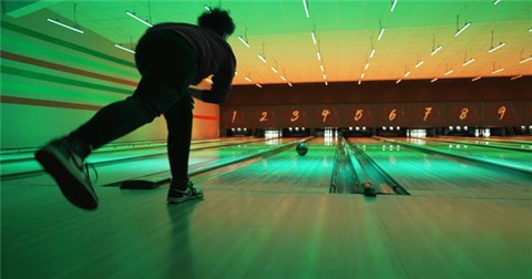 man-rolling-bowling-ball-down-the-lane-towards-pins-1.png
